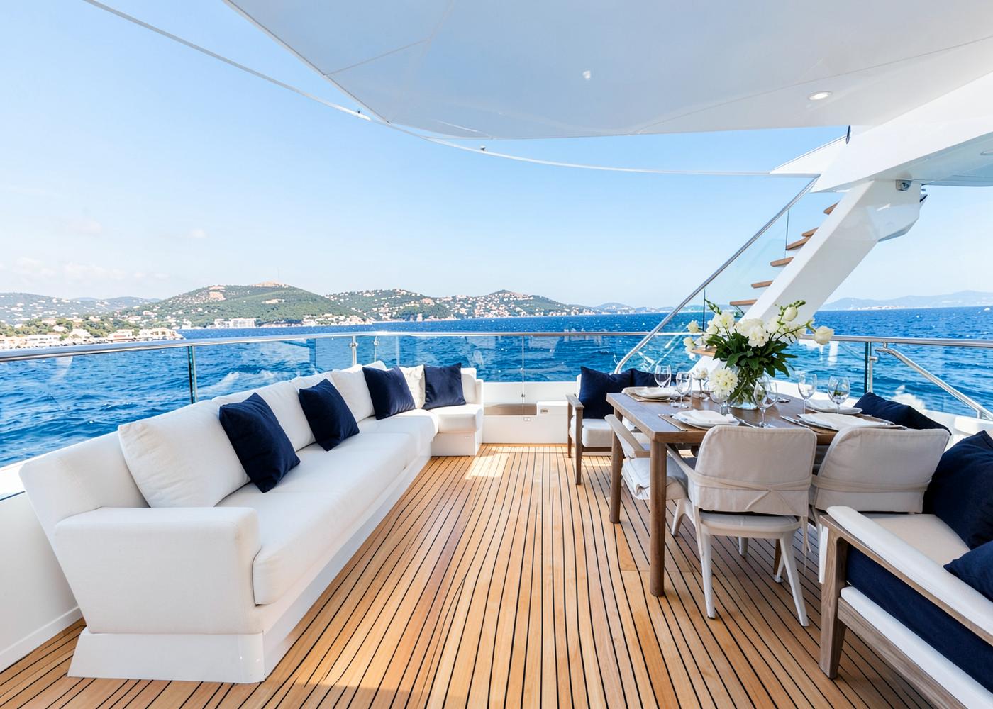 Aft deck lounge and dining area of the Majesty 155 superyacht